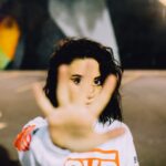 woman wearing white and orange top