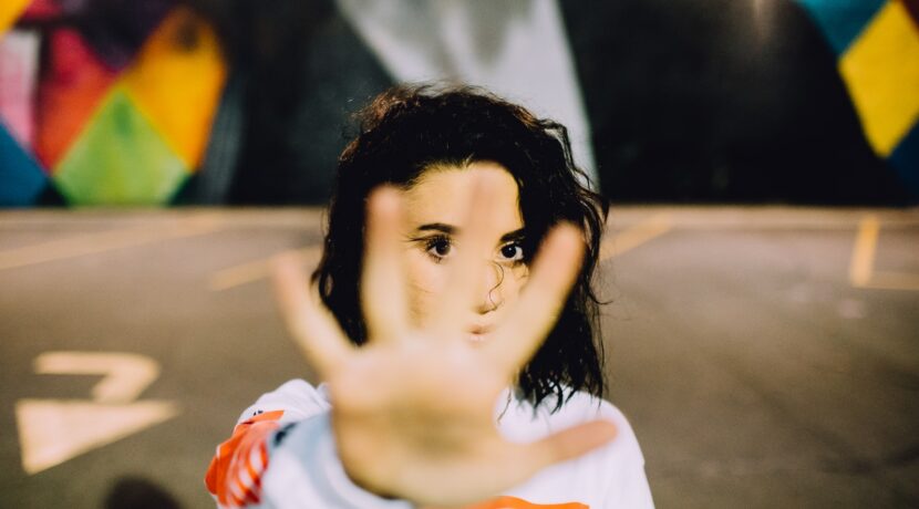 woman wearing white and orange top