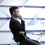 man in black long sleeve shirt sitting on black chair