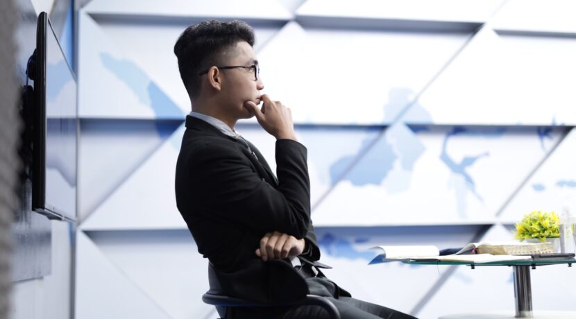 man in black long sleeve shirt sitting on black chair