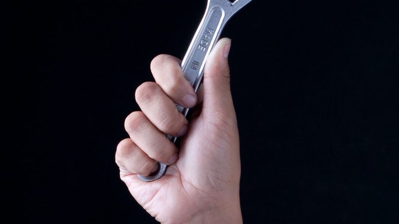 person holding gray and black metal tool