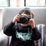 boy holding DSLR camera