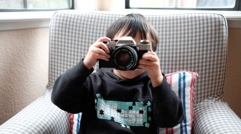 boy holding DSLR camera