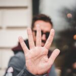 man raising right hand