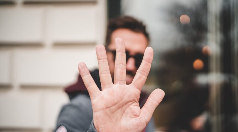 man raising right hand
