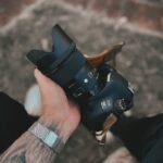 person holding black dslr camera