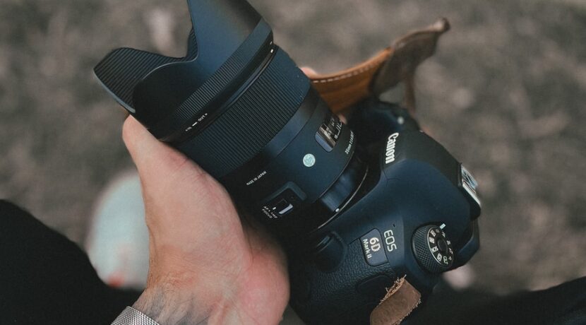 person holding black dslr camera