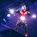person wearing white and red LED light suit