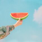 person holding sliced watermelon