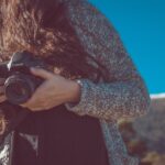 woman holding black Canon DSLR camera