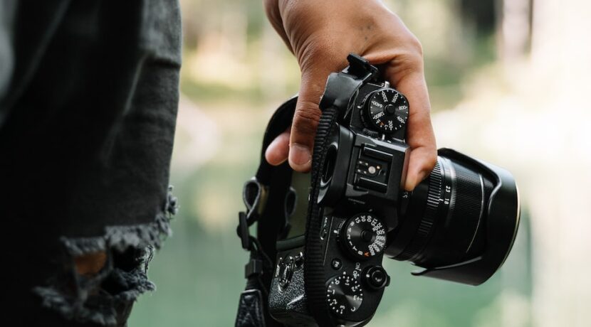 person holding black DSLR camera