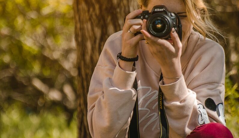woman taking a photo during daytime