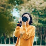 woman holding DSLR camera