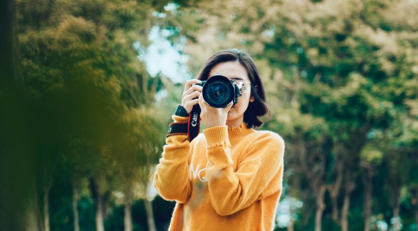 woman holding DSLR camera