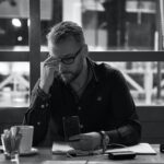 man in black jacket sitting at table