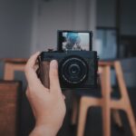 a person holding a camera up to take a picture