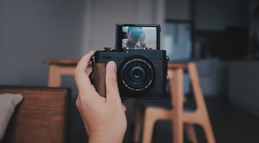 a person holding a camera up to take a picture