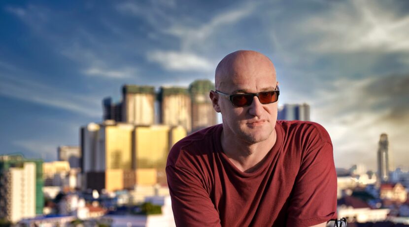man in red crew neck t-shirt wearing black sunglasses