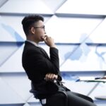man in black long sleeve shirt sitting on black chair