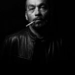 man wearing black leather jacket