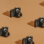 black dslr camera on brown wooden table