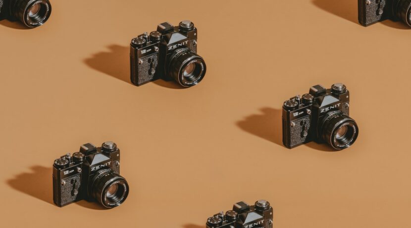 black dslr camera on brown wooden table