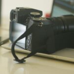a camera sitting on top of a laptop computer