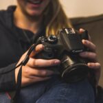 woman holding Canon bridge camera