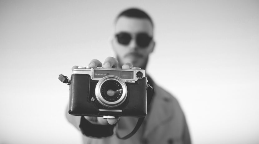 man standing and showing bridge camera