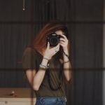 woman taking photo using DSLR camera