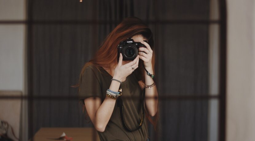 woman taking photo using DSLR camera