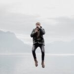 man floating over body of water during daytime