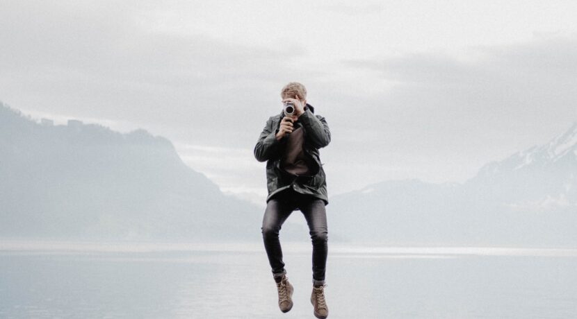 man floating over body of water during daytime
