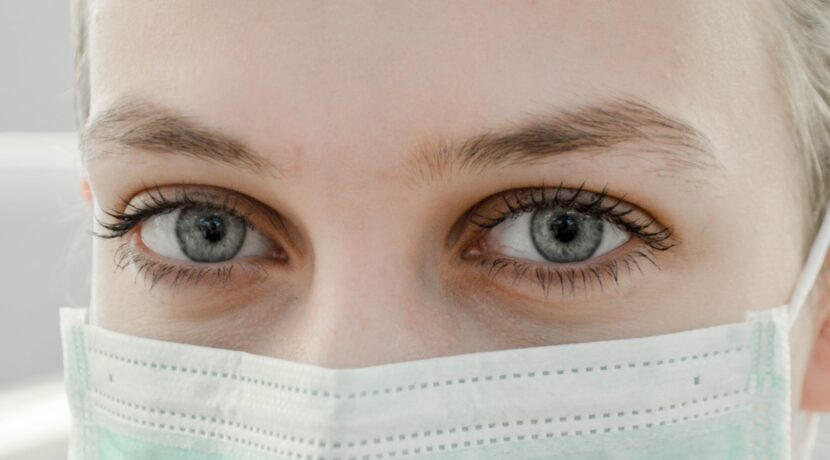 closeup photo of woman's eye wearing mask