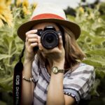 Selective Focus Photography of Woman Holding Dslr Camera