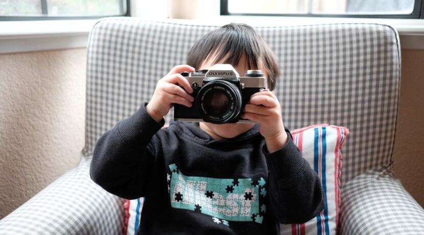 boy holding DSLR camera