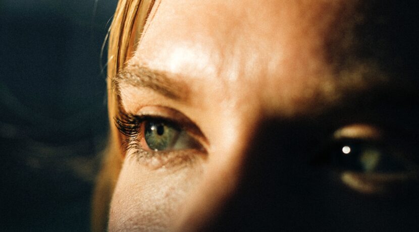 a close up of a person's eye with a blurry background