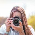 women holding a camera close-up photography