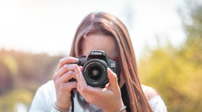 women holding a camera close-up photography