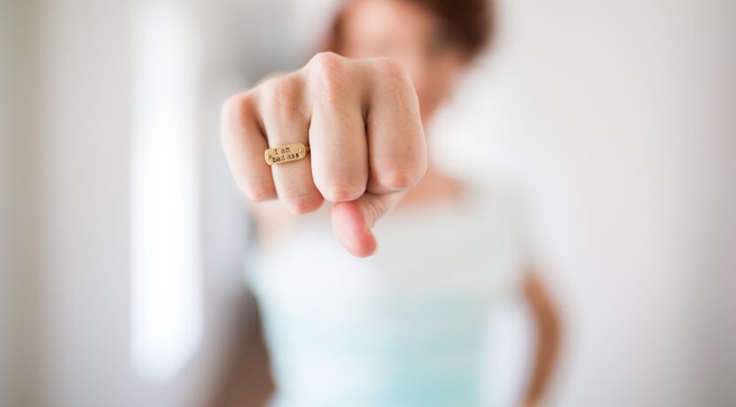woman showing gold-colored ring