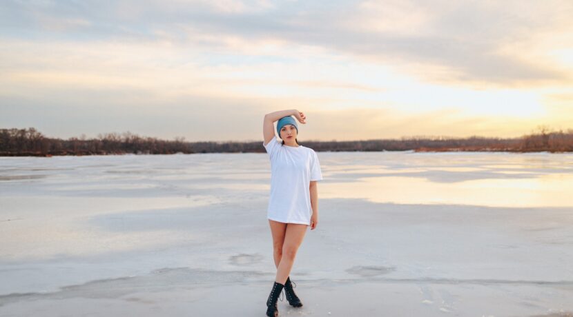 a woman in a white dress standing on a frozen lake