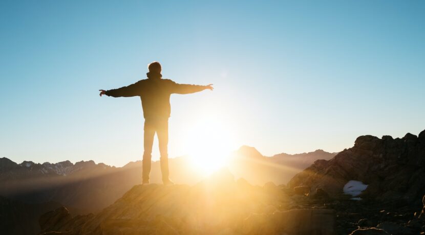person standing on hill