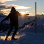 a man riding skis down a snow covered slope