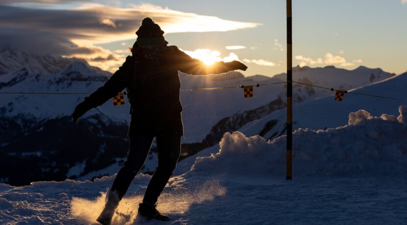 a man riding skis down a snow covered slope