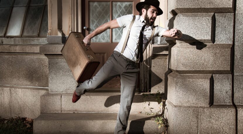 man in white dress shirt and gray pants sitting on gray concrete stairs
