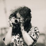 a woman taking a picture with a camera