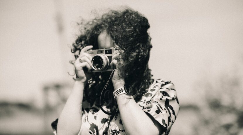 a woman taking a picture with a camera