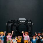 black Fujifilm camera body with minecraft toy lot