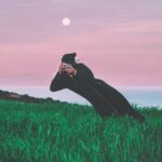 person talking photo in t he middle of grass field