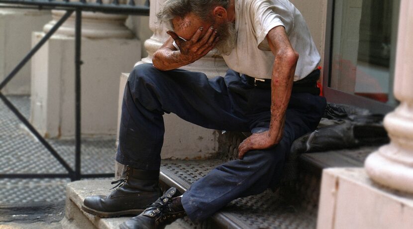 a man sitting on a step with his head in his hands